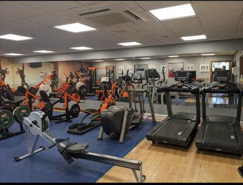 a gym with several treadmills and exercise bikes at Plaza lodge in Gillingham