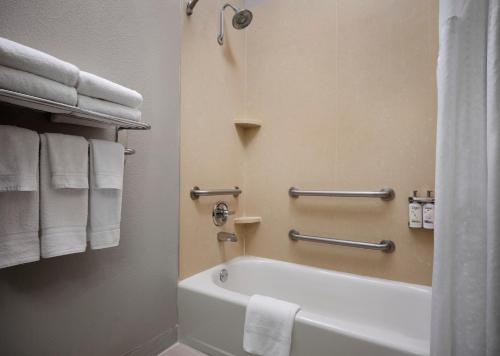 a bathroom with a white bath tub and towels at Holiday Inn Express Hotel and Suites DFW-Grapevine, an IHG Hotel in Grapevine