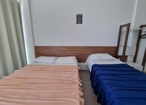 two beds in a small room at Areias do Mar ! 2 Quartos Vista Mar e Varanda A204 in Barra de São Miguel