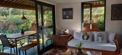 a living room with a white couch and a table at Casa Vila Do Outeiro in Praia do Espelho