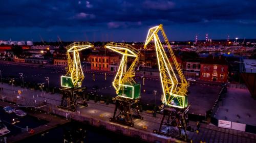 a roller coaster in a city at night at Miodowy Apartament w Hanza Tower -Sauna&Pool in Szczecin