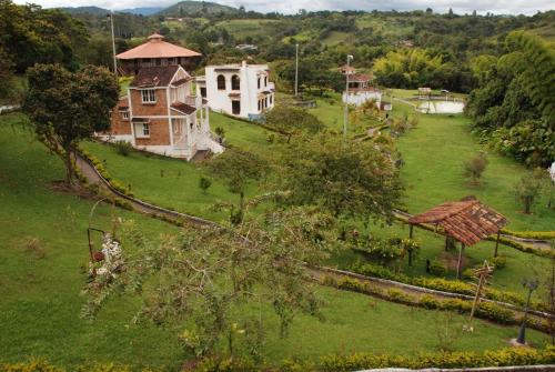 an aerial view of a house in a green field at San Agustin Internacional Hotel in San Agustín