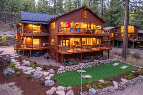 a large wooden house with a green yard at Less Than 1 Mi to Beach Expansive Tahoe Escape with Hot Tub in Incline Village