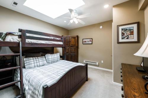 a bedroom with a bunk bed and a ceiling fan at Silver King by All Seasons Resort Lodging in Park City