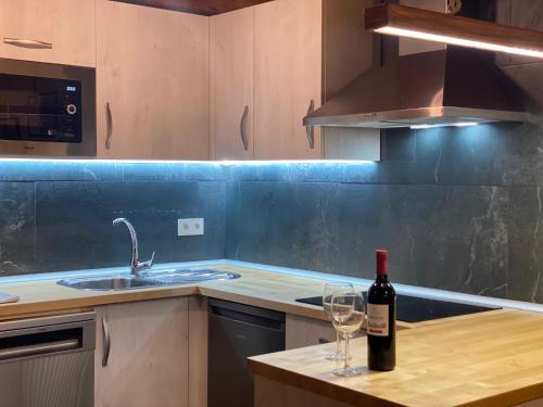 a bottle of wine sitting on a counter in a kitchen at Alojamiento Rural El Molino de Butrera in Butrera