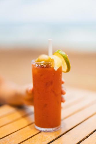 a drink on a table with a slice of lime at Kauai Shores Hotel in Kapaa