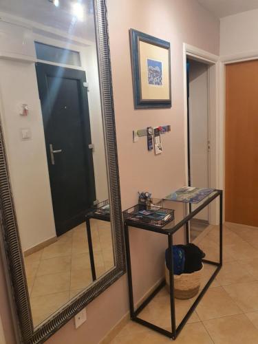 a mirror in a room with a table and a mirror at Batala1-City marina apartment with secured private parking in Dubrovnik