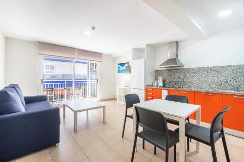 a living room with a blue couch and a table at Apartamentos La Rosita Old Town in Benidorm