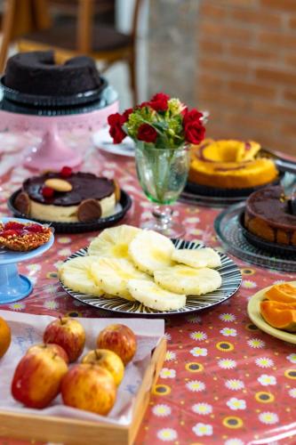 a table topped with plates of food and desserts at Hotel Pousada Santa Maria in Aparecida