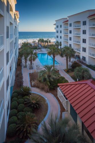 an aerial view of a resort with a swimming pool and the beach at Palm Beach Resort Orange Beach a Ramada by Wyndham in Orange Beach
