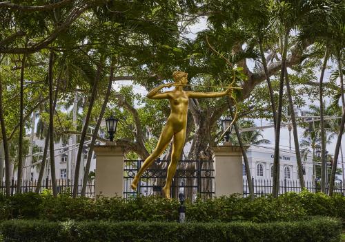 a gold statue of a woman in front of a building at AKA West Palm in West Palm Beach