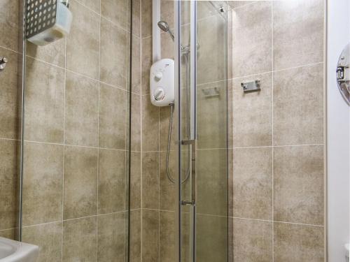 a shower with a glass door in a bathroom at The Old Sweetshop in Par