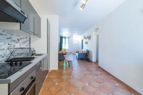 a kitchen with a counter and a table with chairs at L Ethique de Sedan in Sedan
