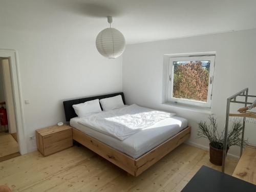 a bedroom with a bed and a window at Hofberg Villa in Landshut