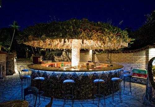 a patio with a table and chairs in front of a building at Nepheli Hotel in Kastrosikia