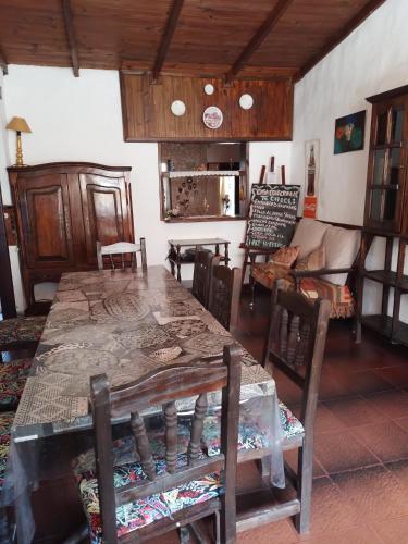 a dining room with a wooden table and chairs at Casa Confortable in Mar del Plata