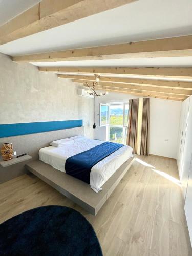 a bedroom with a large bed in a room with a window at Blue Moon Guesthouse in Kamenicë