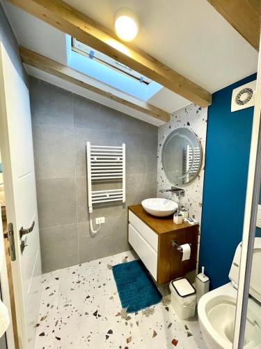a bathroom with a toilet and a sink and a mirror at Blue Moon Guesthouse in Kamenicë