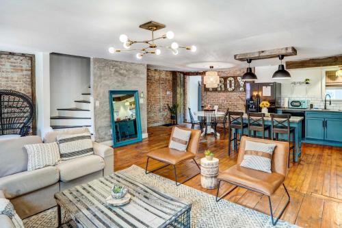 a living room with a couch and a table at Chic Troy Home Near Downtown, 9 Mi to Albany! in Troy