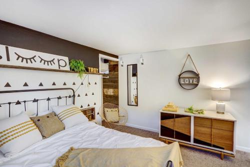 a bedroom with a large bed and a desk at Chic Troy Home Near Downtown, 9 Mi to Albany! in Troy