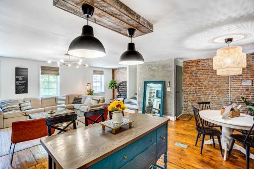 a kitchen and living room with a brick wall at Chic Troy Home Near Downtown, 9 Mi to Albany! in Troy