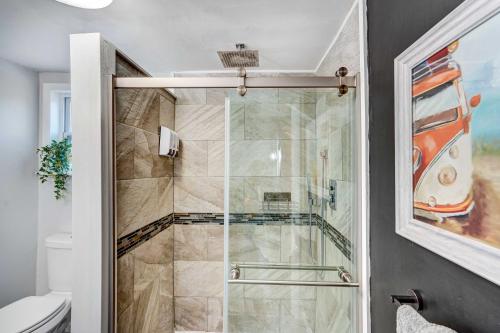 a shower with a glass door in a bathroom at Chic Troy Home Near Downtown, 9 Mi to Albany! in Troy