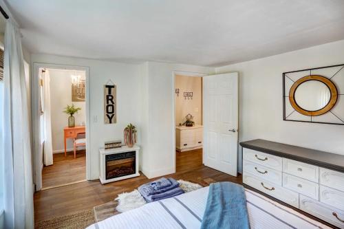 a white bedroom with a bed and a mirror at Chic Troy Home Near Downtown, 9 Mi to Albany! in Troy