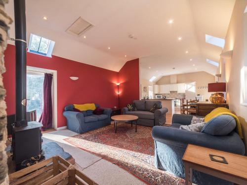 a living room with two couches and a fireplace at Einion - Cefn Coch Farm in Derwenlas