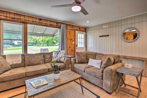 a living room with a couch and a table at Cozy Arden Cottage, 2 Mi to Lake Julian Park! in Arden