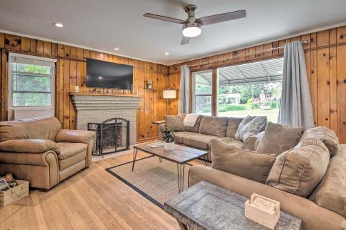 a living room with a couch and a fireplace at Cozy Arden Cottage, 2 Mi to Lake Julian Park! in Arden