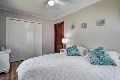 a bedroom with a bed with blue pillows on it at Cozy Arden Cottage, 2 Mi to Lake Julian Park! in Arden