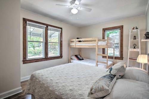 a bedroom with a bed and two bunk beds at Cozy Arden Cottage, 2 Mi to Lake Julian Park! in Arden