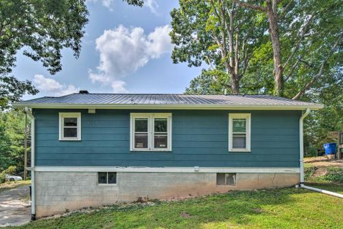 a house with blue siding and trees at Cozy Arden Cottage, 2 Mi to Lake Julian Park! in Arden