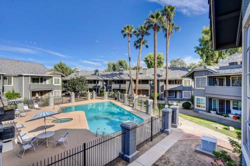 a swimming pool in a villa with palm trees at 7 Mi to Dtwn Chandler Pet-Friendly Condo with Pool in Chandler