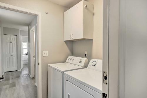 a laundry room with a washer and dryer at Chic Phoenix Home with Yard and Private Heated Pool! in Phoenix