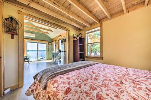 a bedroom with a bed in a room with windows at Quaint Oakland Getaway on East Pond Lake! in Waterville
