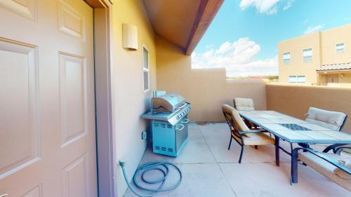 a patio with a table and a grill on a balcony at Wildhorse Canyon #14A3 in Moab