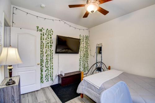 a bedroom with a bed and a tv on a wall at Avondale Getaway Less Than 8 Mi to Estrella Mountain! in Avondale