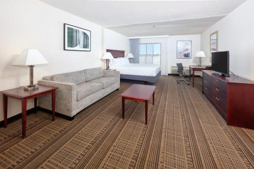 a hotel room with a couch and a bed at Homewood Suites by Hilton Santa Maria in Santa Maria