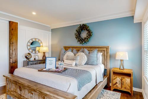 a bedroom with a bed and a wreath on the wall at Coastal Haven - Unit C - Downstairs in Kill Devil Hills