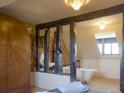 a bathroom with a bath tub and a sink at Doward Farm in Symonds Yat