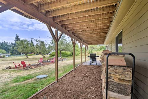 a patio with awning on the side of a house at Cozy Port Orchard Home with Grill and Fire Pit! in Port Orchard