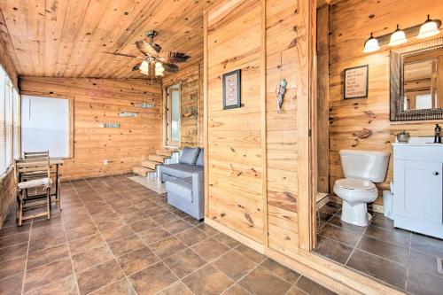 a log cabin bathroom with a toilet and a sink at Gun Barrel City Lake House with Boat Launch and Grill! in Gun Barrel City