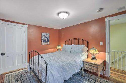 a bedroom with a bed with orange walls at Charming Lambertville Retreat - 1 Mi to River! in Lambertville