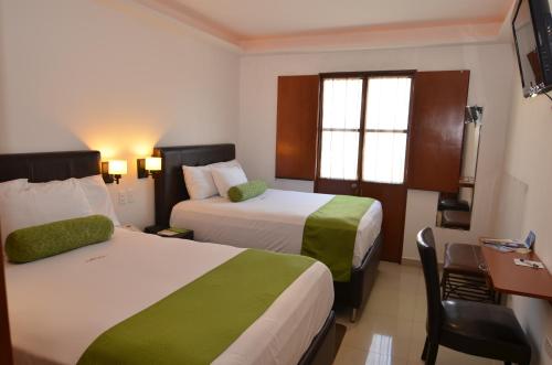 Postel nebo postele na pokoji v ubytování Suites La Concordia