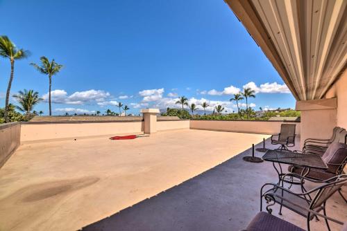 a patio with chairs and a table on a roof at Beautiful Kihei Condo - Walk to the Beach! in Kihei