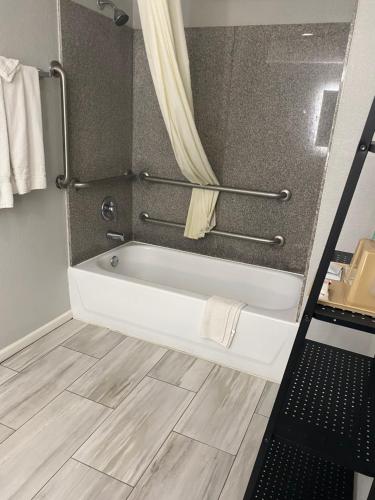 a bathroom with a bath tub in a room at SureStay Hotel by Best Western Spring North Houston in Spring