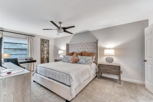 a bedroom with a bed and a ceiling fan at A Foot in the Shore in Naples