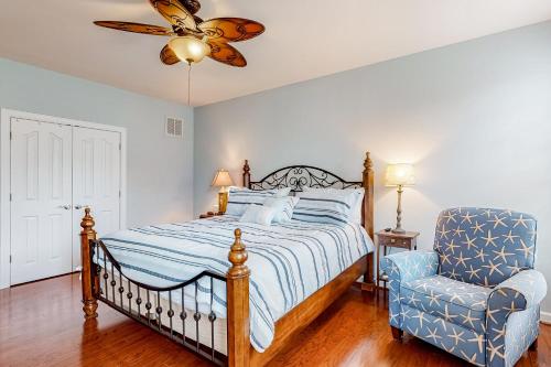 a bedroom with a bed and a chair at Millville by the Sea --- 23772 Pembroke Lane in Millville