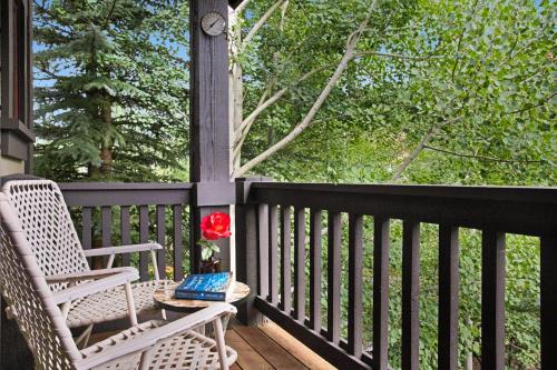 a porch with a chair and a table with a book at 358 Cresta Road in Edwards